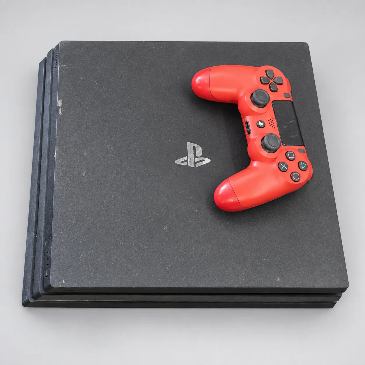 Used Sony PS4 Pro 1TB with one red controller; AI-enhanced background, headset excluded.